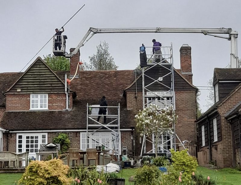 The Roof Moss Cleaners using cherry picker and scaffolding to clean roof safely and professionally in Grove, Oxfordshire